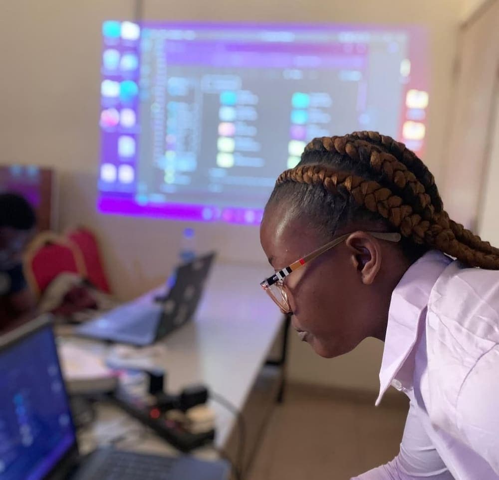 A student working on a laptop in class